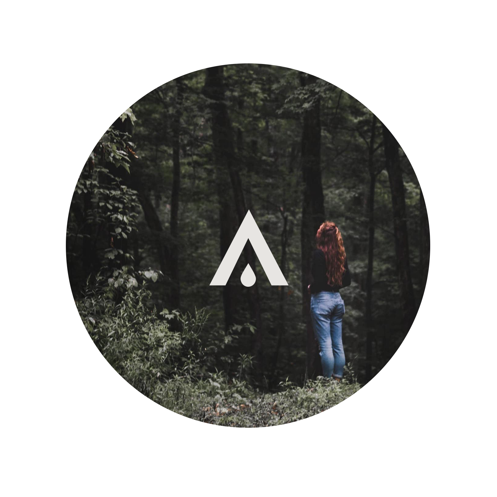 Person standing in a forest with a logo overlay